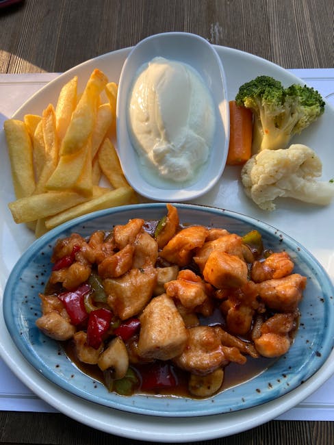 Tasty meal with chicken, fries, veggies, and yogurt, perfect for lunch.