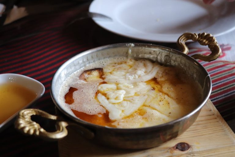 Authentic Turkish breakfast dish in a traditional metal bowl with melted butter.